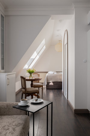 Building with table, chairs, bed in background, interior designの写真素材