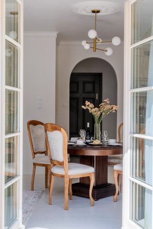 Interior design with furniture, wood table, chairs, chandelier in dining roomの写真素材