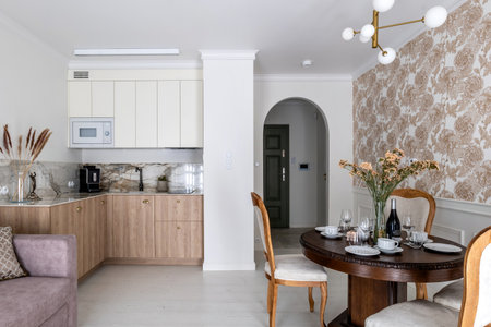 House interior design with living room, dining table, chairs, and kitchenの写真素材