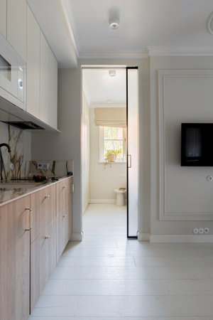 a kitchen with a sliding glass door leading to a living roomの写真素材