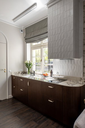 A kitchen with cabinetry, wood flooring, and a sinkの写真素材