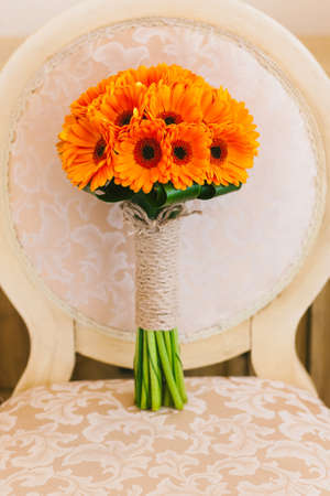 Beautiful wedding bouquet of orange flowers. No people. Vertical color photo.の写真素材