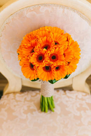 Beautiful wedding bouquet of orange flowers. No people. Vertical color photo.の写真素材