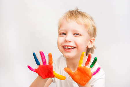 Little boy hands painted in colorful paints on whiteの写真素材