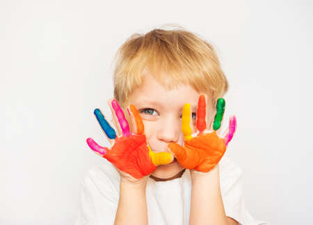 Little boy hands painted in colorful paints on whiteの写真素材