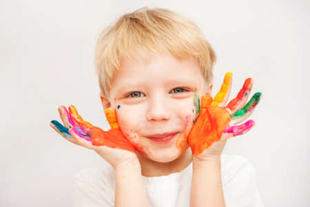 Little boy hands painted in colorful paints on whiteの写真素材