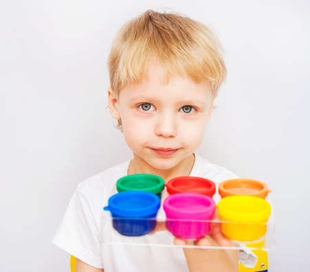 Little boy hands painted in colorful paints on whiteの写真素材