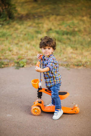 Boy playing outdoors, having fun in the parkの写真素材