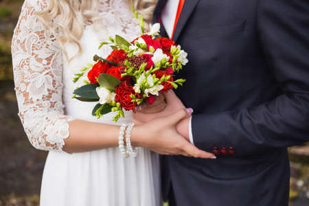 Elegant bride and groom posing together outdoors on a wedding dayの写真素材