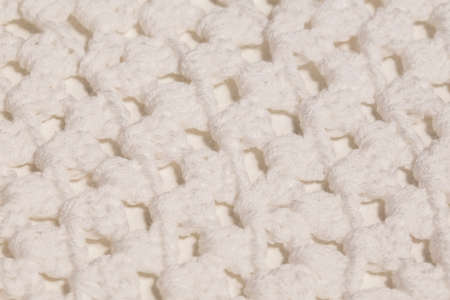 Macro color image of white knitted texture.