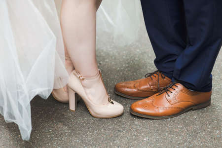 Closeup view of wedding couple posing outdoors for professional photographer.の写真素材