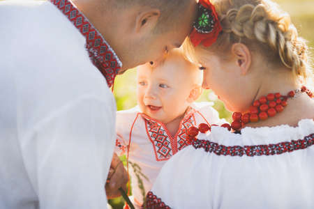 Portrait of ethnic ukrainian family wearing traditional white clothes.