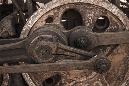 Closeup view of wheels of abandoned old rusty soviet locomotive at platform. Horizontal color...