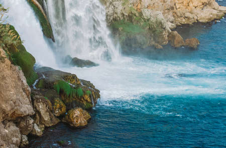 Beautiful waterfall with rainbow in water drops in Antalya city, Turkey country, Mediterranean sea....
