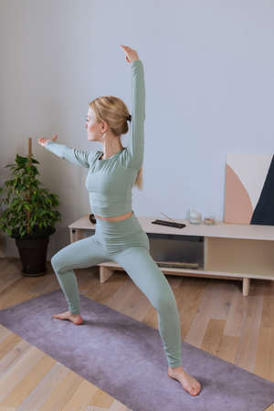 A young woman in the lotus position hands in the namase pose. The process of relaxation during a...