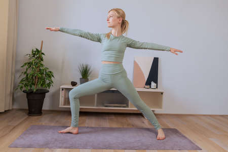 A young woman in the lotus position hands in the namase pose. The process of relaxation during a...