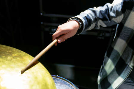 Close-up of a drummer's hand with sticksの写真素材