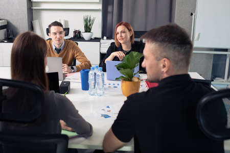 A team of office workers at the table discussing new projectsの写真素材