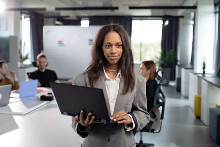 African american businesswoman with a laptop in the officeの写真素材