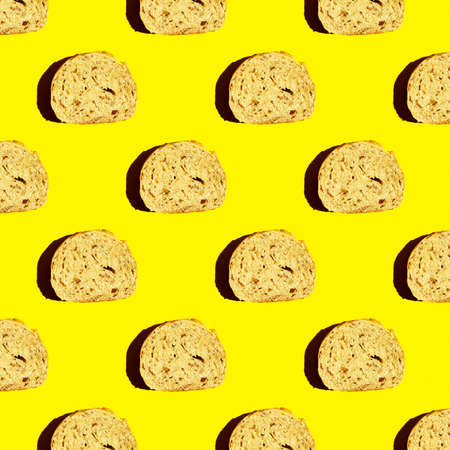 Top view of the pattern of a piece of cut bread on a yellow background. morning food