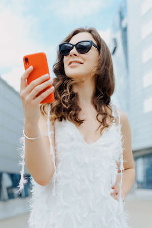 Close-up of a woman's hand holding the car key. Buying a new car. Focus on keyの写真素材