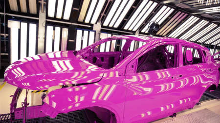 Car manufacturing plant, on the pink car painting lineの写真素材
