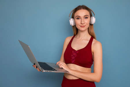 Young woman trains online with a sports coachの写真素材