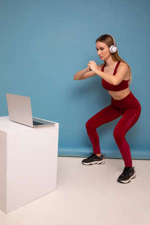 Young woman trains online with a sports coachの写真素材
