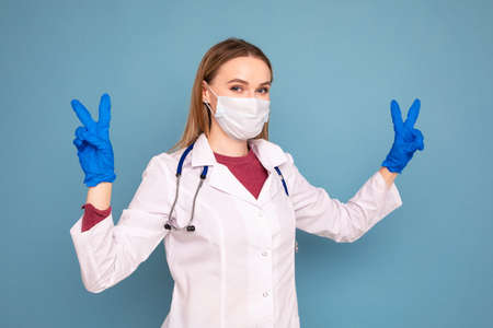 Portrait of a female doctor on a blue backgroundの写真素材