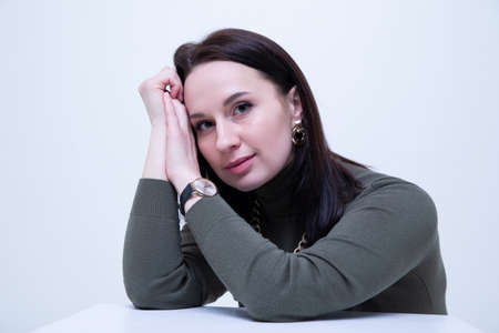 Fashion portrait of a young brunette woman in a dark golf