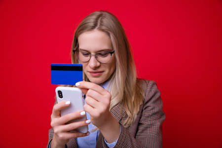 Young woman makes online purchases using a mobile phone