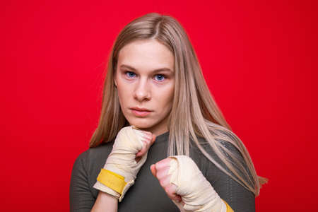 Athletic female boxer on red backgroundの写真素材
