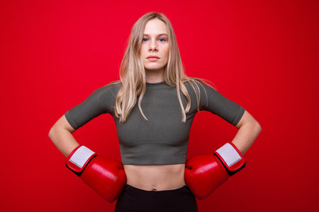 Athletic young woman in red boxing gloves in trainingの写真素材