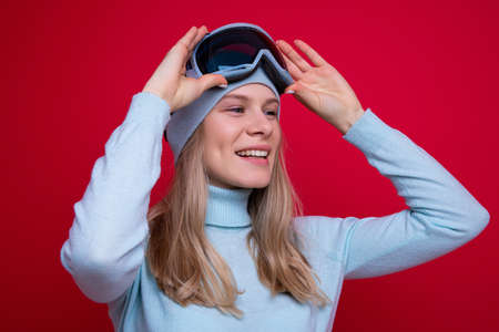 Portrait of a young woman in a sweater and ski gogglesの写真素材