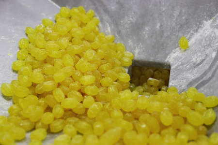 Close-up of yellow lollipops. Factory for the production of sweets