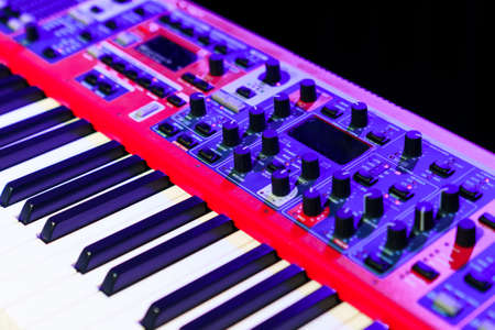 Close-up of an electronic synthesizer on a dark backgroundの写真素材