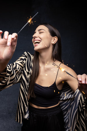 Portrait of a young woman with sparklers.