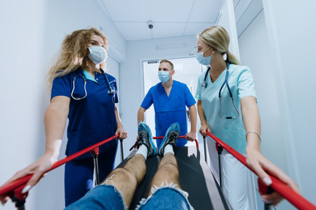 First-person view.A professional team of paramedics is rolling a gurney with a patient along the...