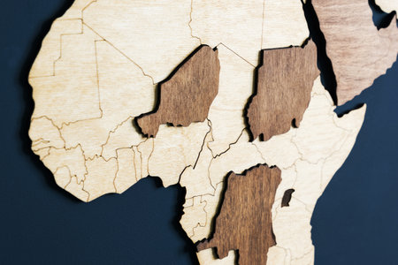 Close-up of Africa on a wooden map on a dark wall. Travel to South African countries.