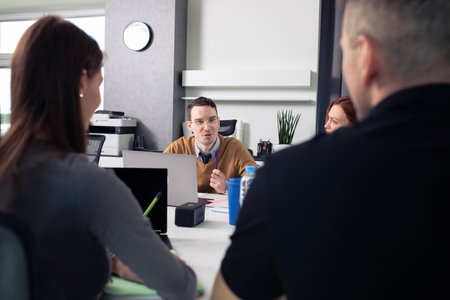 A team of office workers at the table discussing new projects