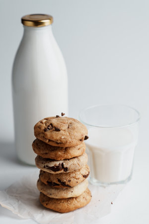 A composition of cookies, glass and a bottle of milkの写真素材
