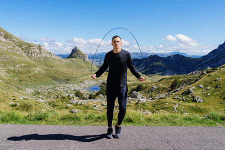 outdoor training. Athlete jumps on a rope, warm-up before training.の写真素材