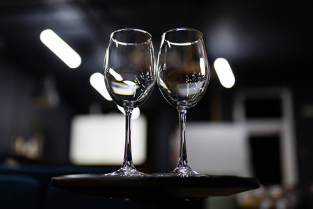 Two clean empty glasses on the table before the wine tasting. Beautiful light falls on the glassの写真素材