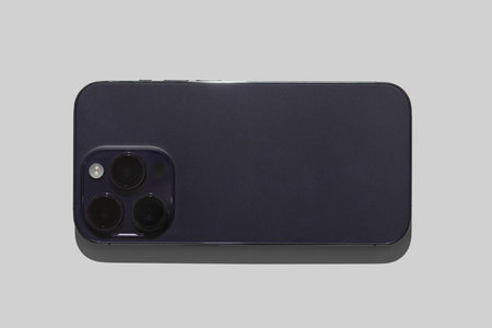 Technologies of modern phones. The smartphone lies upside down with a block of cameras on a white...