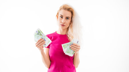A young woman holds euro banknotes on a white background.Wages in European countries
