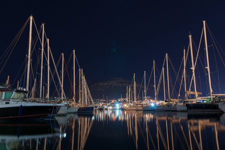 Kotor, Montenegro - February 15, 2023: Night marina with yachts on the background of mountains....