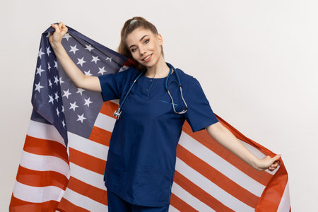 A family physician on a white background with the Stars and Stripes of the United States in the backdropの写真素材