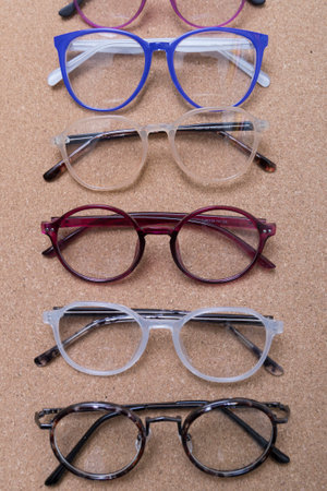 Different eyeglass frames on cork boardの写真素材