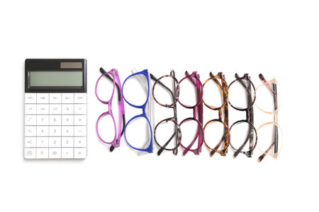 Calculator and different eyeglass frames on white background. Isolatedの写真素材