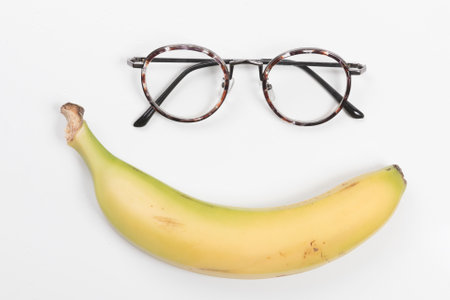 The eyeglass frame and yellow banana look like a smiling faceの写真素材